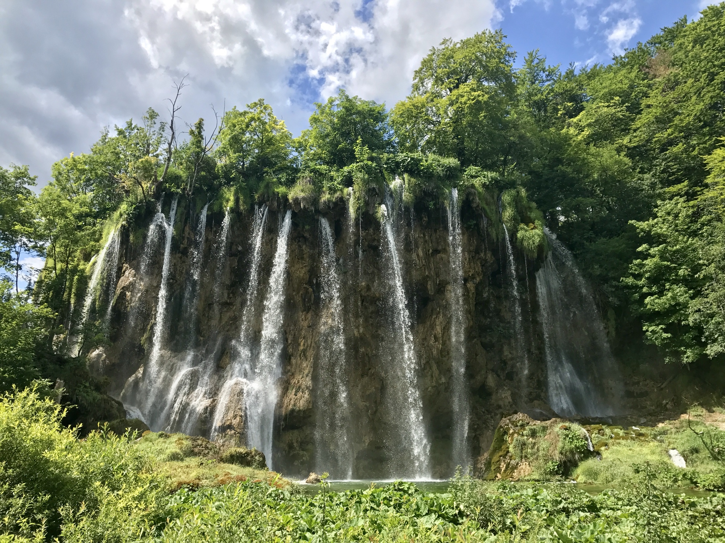 Waterfalls at Plitvice Lakes surrounded by forest